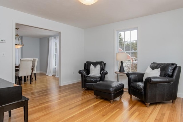 sitting room with light wood-type flooring and baseboards