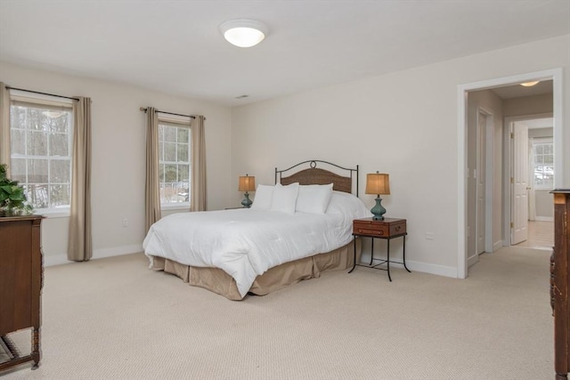 bedroom with carpet flooring, multiple windows, and baseboards