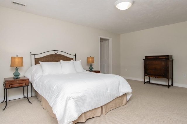 bedroom featuring visible vents, baseboards, and light colored carpet