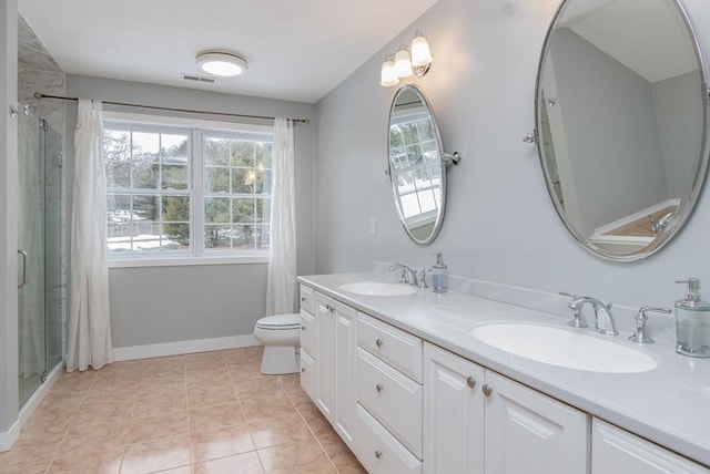 bathroom featuring tile patterned floors, a stall shower, visible vents, and a sink