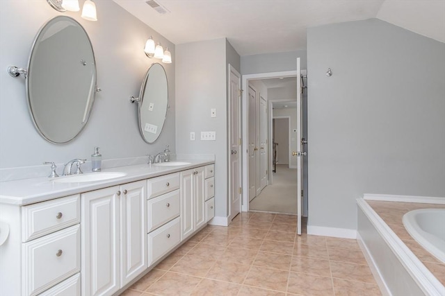 bathroom with a sink, visible vents, double vanity, and tile patterned floors