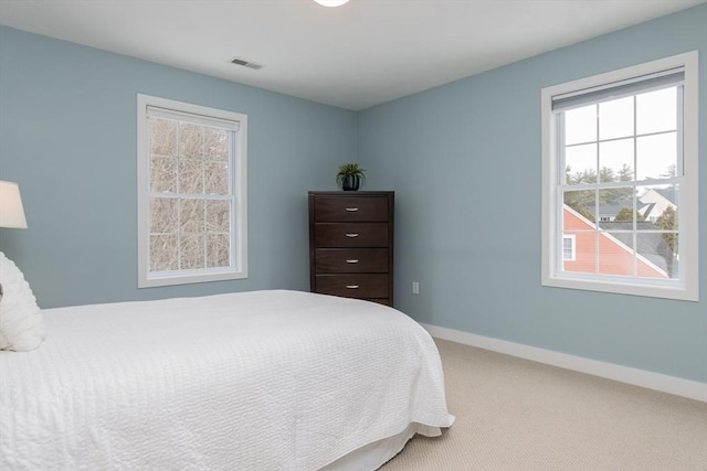 bedroom with visible vents, baseboards, and carpet flooring