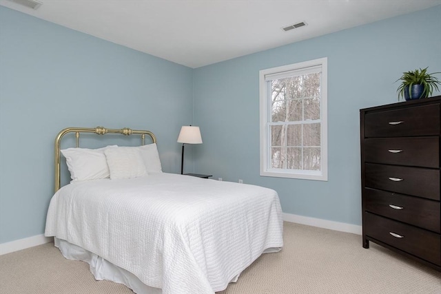 bedroom featuring light colored carpet, baseboards, and visible vents