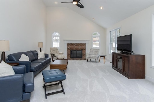 living room with baseboards, high vaulted ceiling, a fireplace, recessed lighting, and light colored carpet