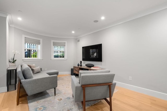 living room with ornamental molding and hardwood / wood-style floors