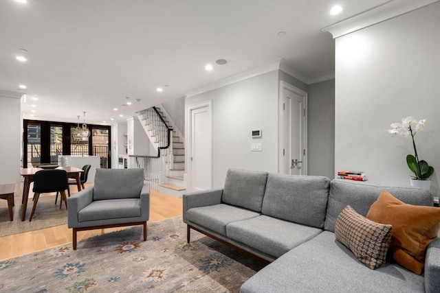 living room with ornamental molding and hardwood / wood-style floors