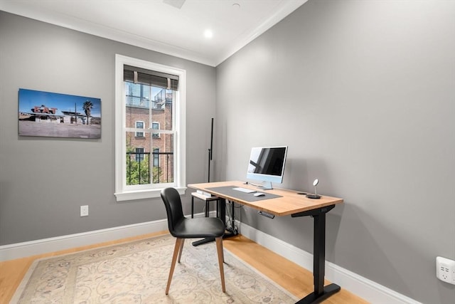 home office with hardwood / wood-style flooring and ornamental molding