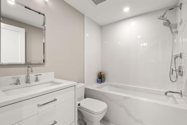 full bathroom featuring tiled shower / bath combo, vanity, and toilet