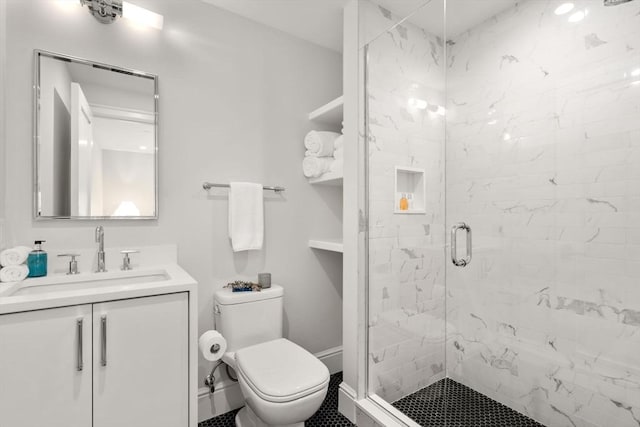 bathroom with vanity, a shower with shower door, and toilet