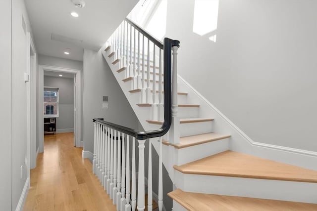 stairway featuring wood-type flooring