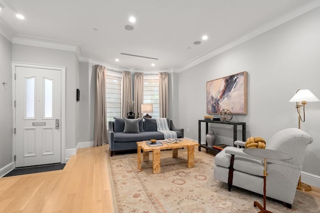 living room featuring crown molding and light hardwood / wood-style flooring