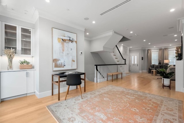 interior space with crown molding and light hardwood / wood-style flooring