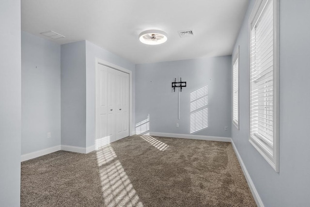 carpeted spare room with plenty of natural light