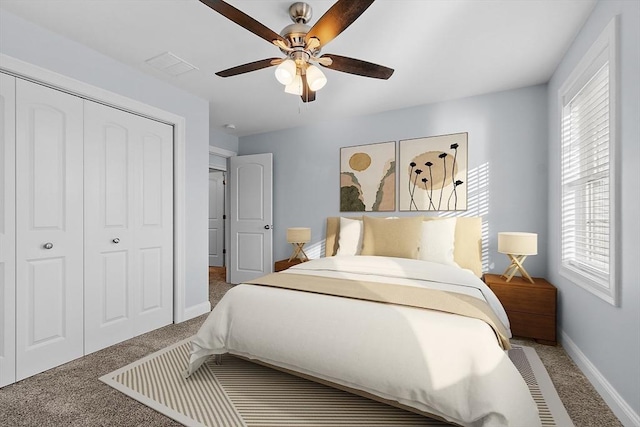 bedroom with carpet, a closet, multiple windows, and ceiling fan