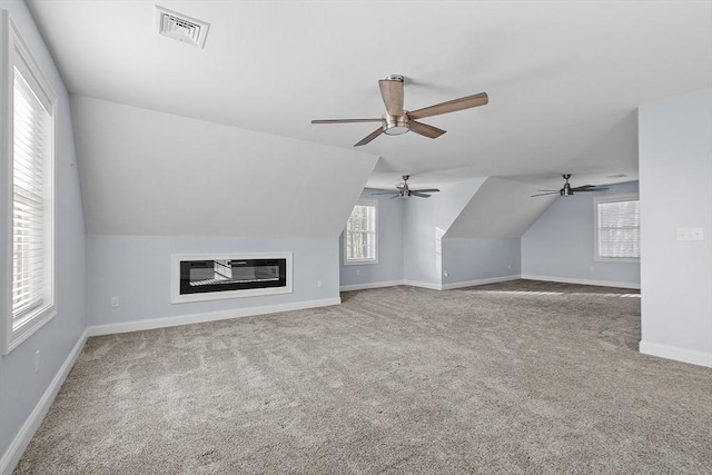 bonus room featuring carpet, plenty of natural light, and lofted ceiling