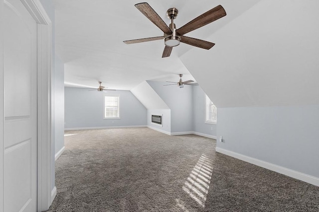 additional living space with carpet floors, vaulted ceiling, and ceiling fan