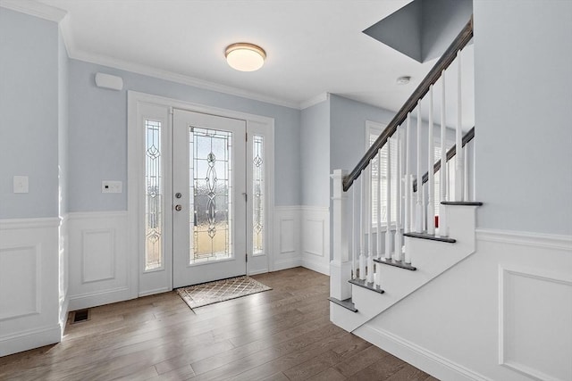 foyer with hardwood / wood-style floors and ornamental molding