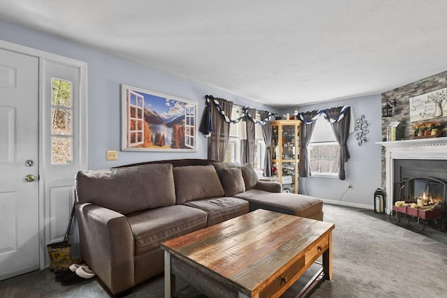 living room with carpet flooring, a large fireplace, and baseboards