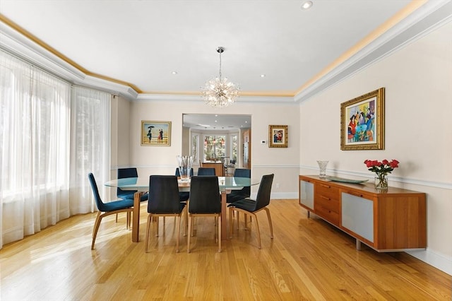 dining room with a chandelier, baseboards, light wood-style floors, and ornamental molding