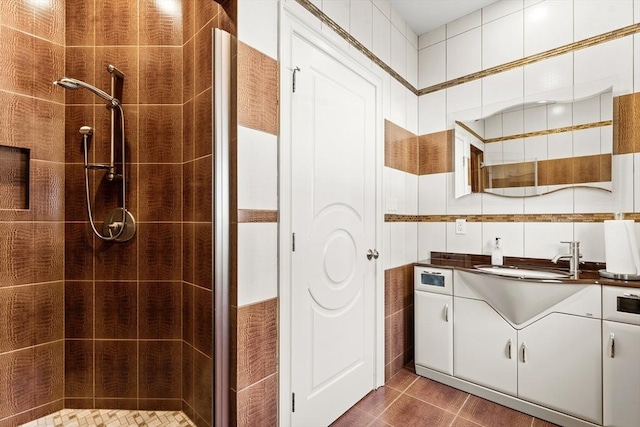 full bath with vanity, a shower stall, and tile patterned flooring