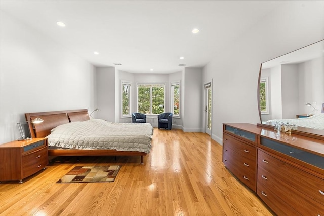 bedroom with recessed lighting, light wood-type flooring, and baseboards