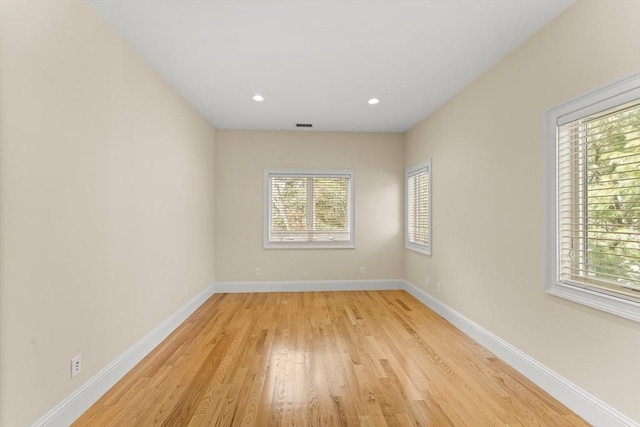 unfurnished room with visible vents, recessed lighting, light wood-style floors, and baseboards