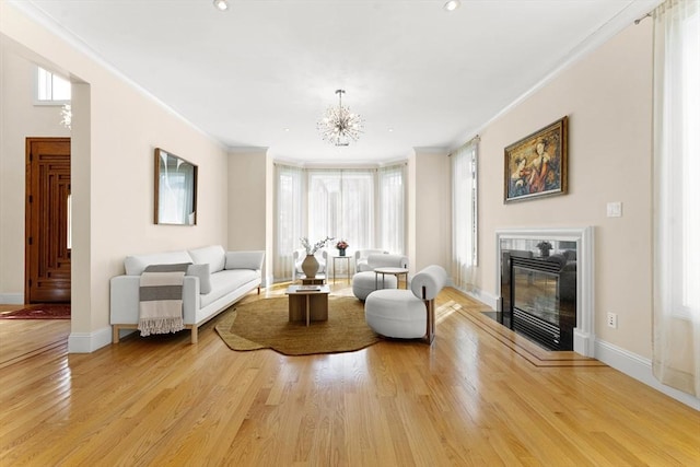 living area featuring plenty of natural light, light wood-style floors, and a premium fireplace