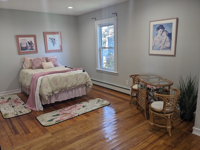 bedroom featuring hardwood / wood-style flooring and baseboard heating