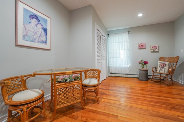 sitting room with light wood-type flooring and baseboard heating