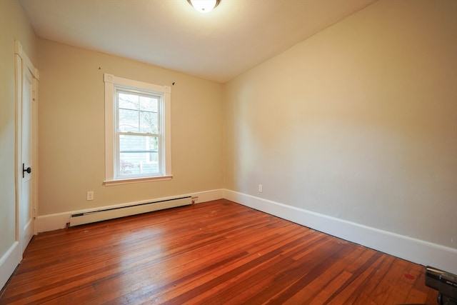 unfurnished room featuring baseboard heating and wood-type flooring