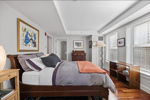 bedroom with light hardwood / wood-style flooring and multiple windows