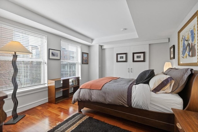 bedroom with light wood-type flooring and multiple windows