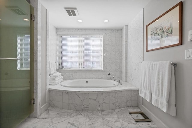 bathroom with shower with separate bathtub