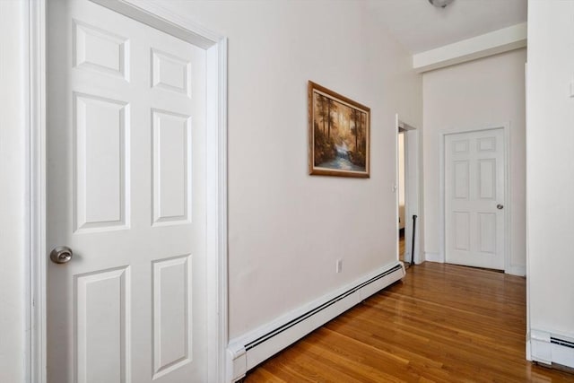 hallway featuring a baseboard radiator and wood finished floors