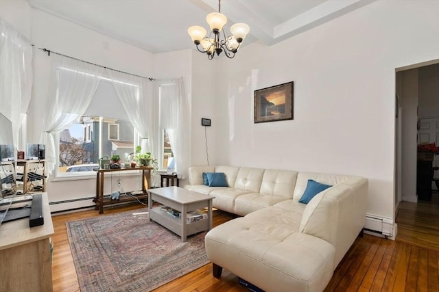 living room with a baseboard radiator, a chandelier, and hardwood / wood-style floors