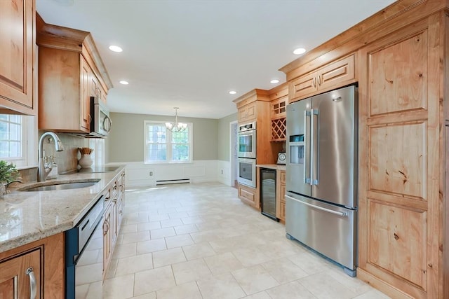 kitchen with stainless steel appliances, a sink, a chandelier, beverage cooler, and a wainscoted wall
