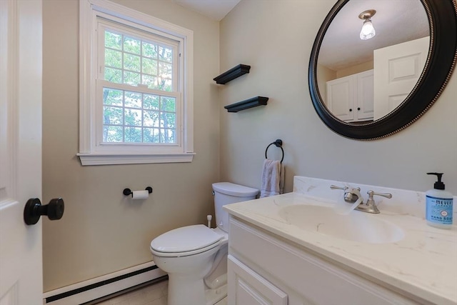 half bath featuring a baseboard heating unit, toilet, and vanity