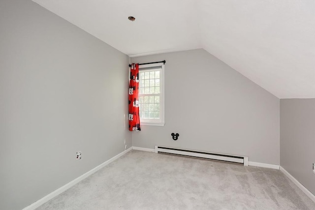 bonus room with a baseboard heating unit, lofted ceiling, light carpet, and baseboards