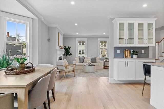 73 Knoll St Unit 73, Boston, MA 02131 - dining area with light wood-style flooring, recessed lighting, stairs, crown molding, and a fireplace