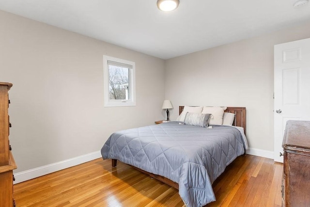 bedroom with baseboards and wood-type flooring