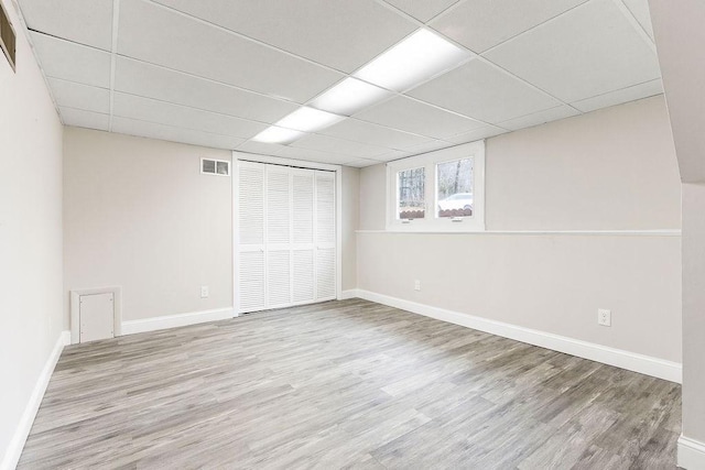 interior space with visible vents, a paneled ceiling, and wood finished floors