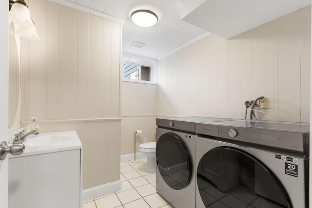 laundry room with visible vents, washer and dryer, a sink, light tile patterned floors, and laundry area