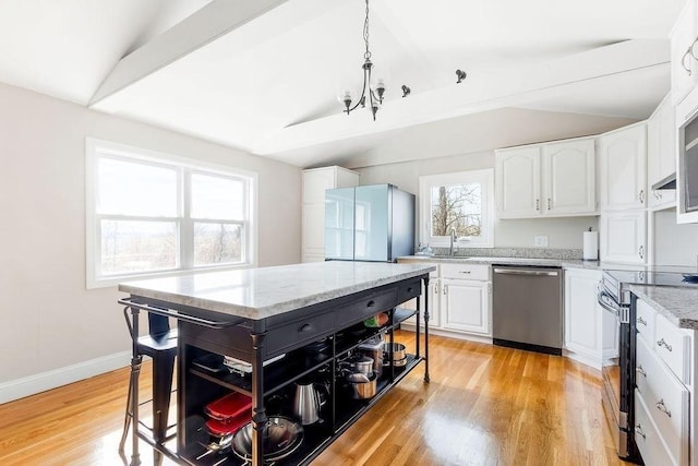 kitchen featuring open shelves, stainless steel appliances, light wood finished floors, and vaulted ceiling