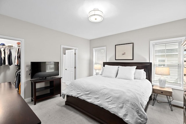 54 Sunflower Way, Plymouth, MA 02360 - bedroom with a walk in closet, light colored carpet, a closet, and baseboards