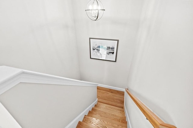 54 Sunflower Way, Plymouth, MA 02360 - stairway with a chandelier, wood finished floors, and baseboards