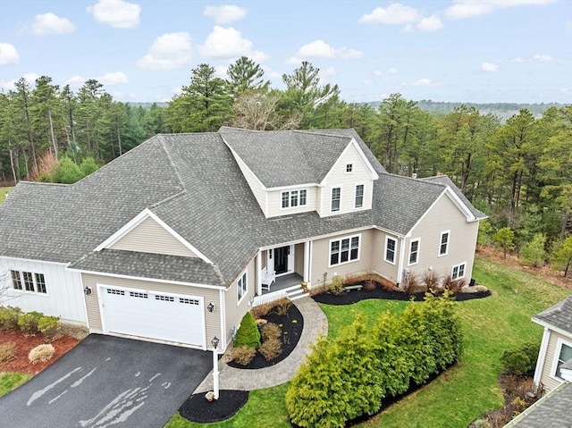 54 Sunflower Way, Plymouth, MA 02360 - view of front of property featuring driveway, a garage, a front lawn, roof with shingles, and a wooded view