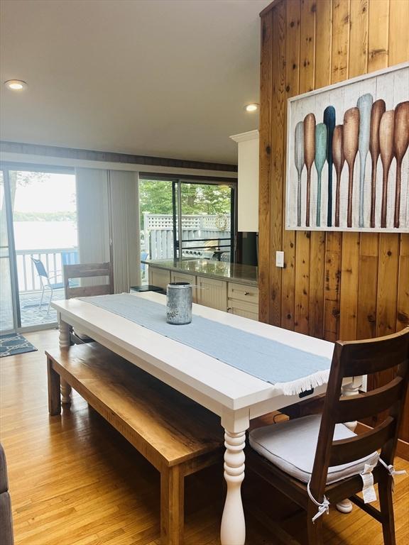 233 Hoopdole Rd, Mashpee, MA 02649 - dining area with light wood-style flooring, recessed lighting, and wooden walls