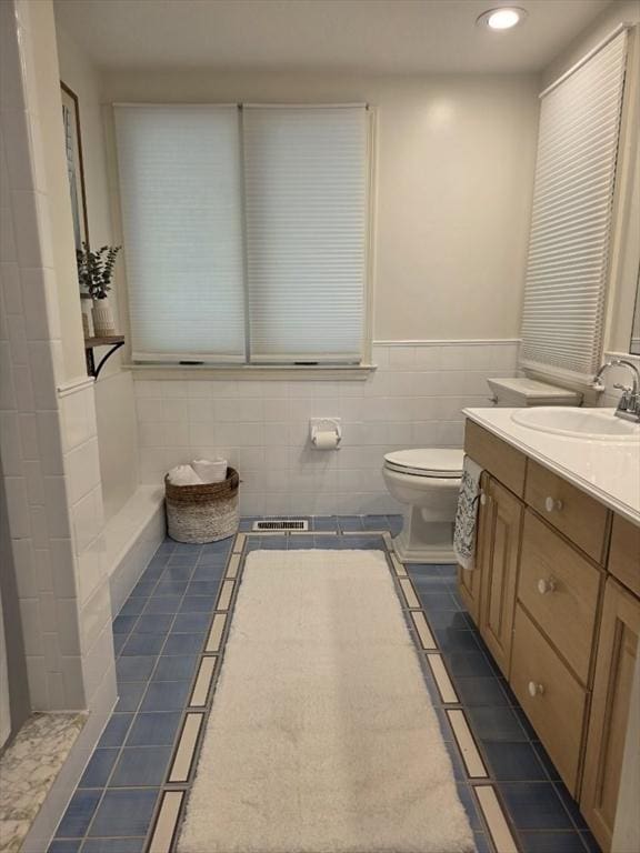 233 Hoopdole Rd, Mashpee, MA 02649 - full bath featuring vanity, tile patterned floors, tile walls, recessed lighting, and wainscoting