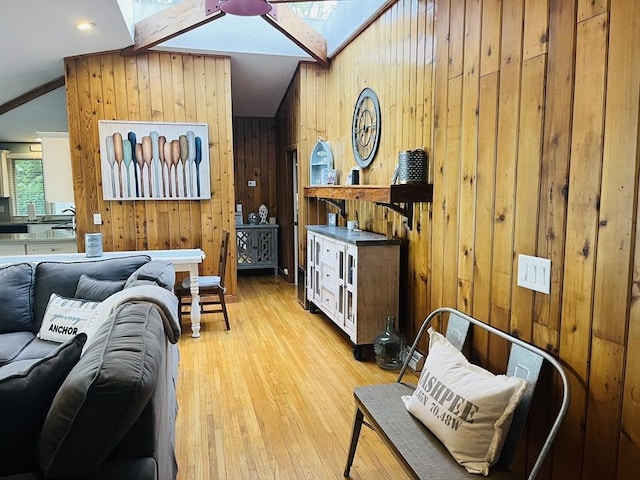 233 Hoopdole Rd, Mashpee, MA 02649 - living room featuring wooden walls, a skylight, vaulted ceiling, and wood finished floors