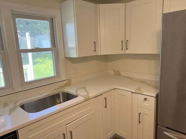35 Woodland Rd, Leominster, MA 01453 - kitchen with freestanding refrigerator, white cabinetry, and light stone counters